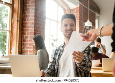 Excited businessman receiving document with financial statistics in office happy about achievement success growth, smiling employee giving project report to executive satisfied with good work result