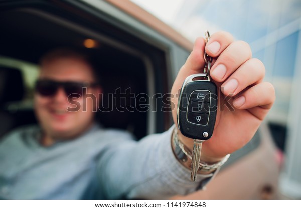 Excited\
Businessman Sitting In Car Showing New Car\
Key