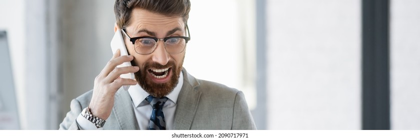 Excited Businessman Talking On Mobile Phone In Office, Banner