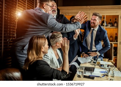 Excited businessmen springing from seats, happily smiling shaking hands, consummating good deal in business conference - Shutterstock ID 1536719927
