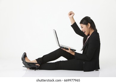 An excited businesswoman on laptop