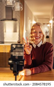 Excited Caucasian Woman, Holding Up Two Fingers While Making A Self Portrait.