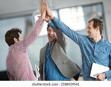 Excited, cheerful and happy group of male business people high fiving for motivation in an office. Group of professional work colleagues show support and celebrating after a team building meeting. - Shutterstock ID 2188929541