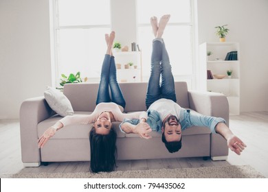 Excited Cheerful Joyful Amazing Amusing Lovely Tender Brother And Sister Are Having Fun And Posing Upside-dowm On A Couch At Home At The Weekend