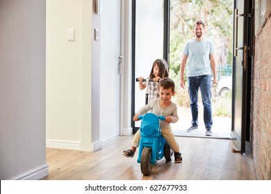 Excited Children Arriving Home With Father