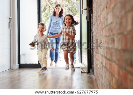 Excited Children Arriving Home With Parents