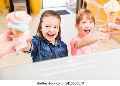 Excited children getting their ice cream at the counter 