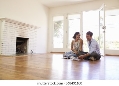 Excited Couple Planning Decoration Of New Home