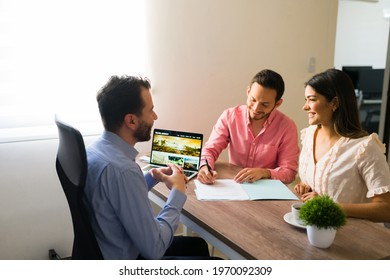 Excited couple signing a sales contract and timeshare at a travel agency and feeling happy for their upcoming holiday vacations