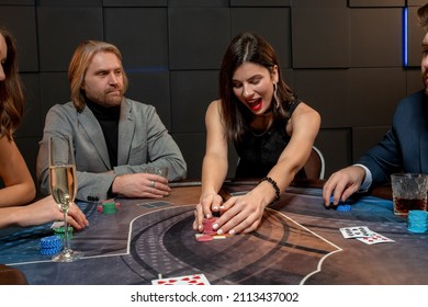 Excited Dark-haired Girl Winning Poker Game, Raking Pile Of Chips