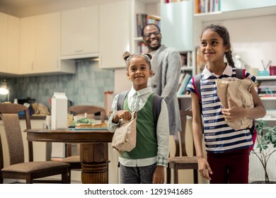 Excited Daughters. Two Funny Stylish Daughters Feeling Excited While Leaving To School With Lunchboxes