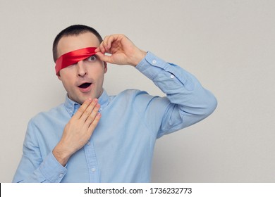 Excited And Dazed Man Removes Red Blindfold, Portrait, White Background, Copy Space