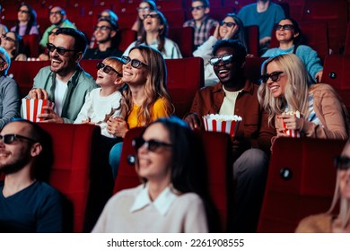 An excited diverse crow is in the movie theater enjoying a 3D movie on the big screen. - Powered by Shutterstock