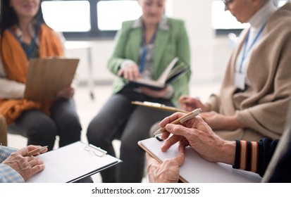 Excited Elderly People Attending Group Therapy Session At Nursing House, Positive Senior Man And Woman Sitting In Circle, Having Conversation With Psychologist