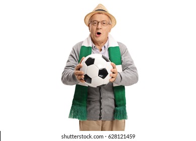 Excited elderly soccer fan with a scarf and a football cheering isolated on white background