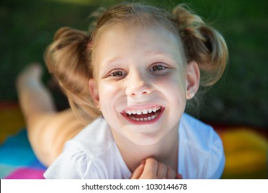 Excited Face Of Pretty Small Girl In Summer Park