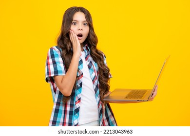 Excited Face. Smart Little Boy With Laptop In Casual Clothes Isolated Over Yellow Background. Shocked Surprised Teenager School Girl.