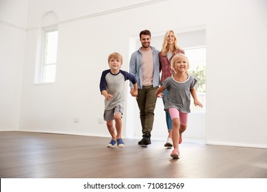 Excited Family Explore New Home On Moving Day