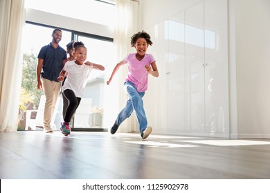 Excited Family Exploring New Home On Moving Day