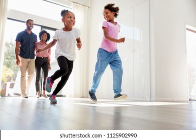 Excited Family Exploring New Home On Moving Day