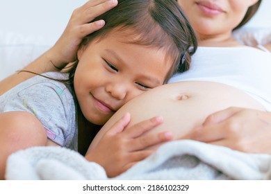 A Excited Family Talking To The Pregnant Belly.  New Family Member.