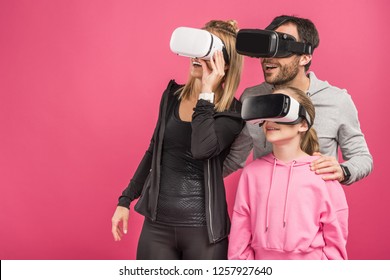 excited family using vr headsets, isolated on pink - Powered by Shutterstock