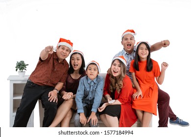 Excited Family Watching Tv Together Wearing Christmas Head