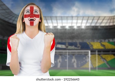 Excited Fan England In Face Paint Cheering Against Football Pitch In Large Stadium