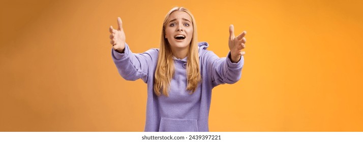 Excited fascinated glad blond woman adore singer performing stage extend arms forward reaching camera wanna hold tight cuddle embrace love open mouth passionately look, orange background. - Powered by Shutterstock