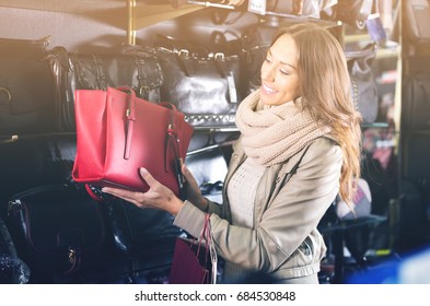 Excited Female Customer Purchasing New Handbag In Shop