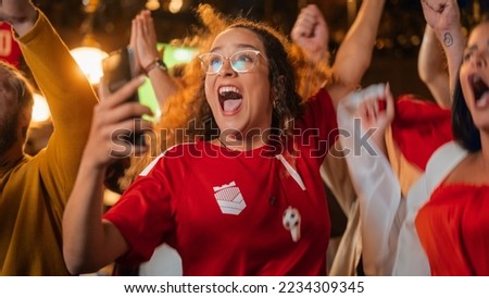Excited Female Holding a Smartphone, Nervous About the Sports Bet She Put on a Her Favorite Soccer Team. Ecstatic Emotions When Football Team Scores a Goal and She Wins a High Stakes Lottery Prize. Stok fotoğraf © 