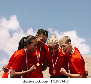 Excited Female Soccer Players Shouting In Joy After Winning The Championship. Woman Football Team With Medals Celebrating Victory.