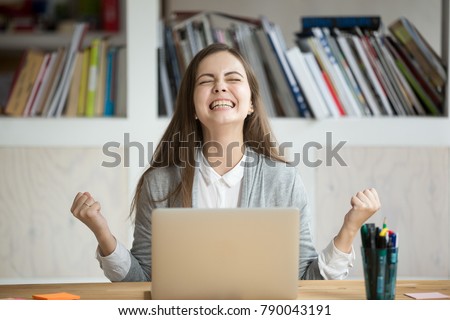 Excited female student feels euphoric celebrating online win success achievement result, young woman happy about good email news, motivated by great offer or new opportunity, passed exam, got a job