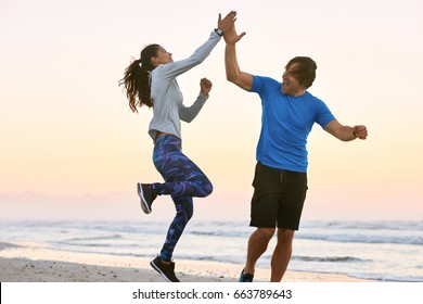 Excited Friends Couple High Five Jump In Celebration After Training Their Gruelling Exercise Workout Run