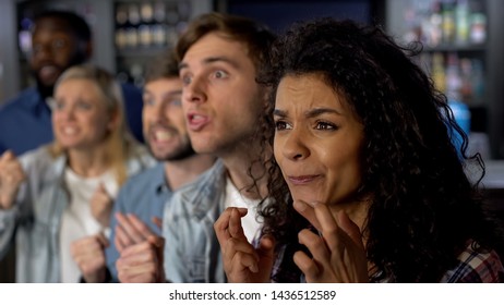 Excited friends crossing fingers watching tv competition, fans at sport event - Shutterstock ID 1436512589