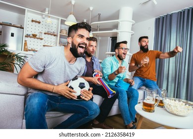 Excited friends watching football game and holding beer and popcorn