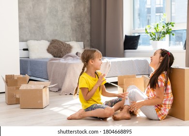 Excited Funny Kids Girls Running Inside Luxury Big Modern House On Moving Day, Cute Children Entering Exploring New Home, Happy Young Family Buying Real Estate