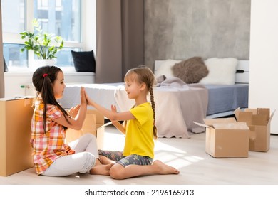 Excited Funny Kids Girls Running Inside Luxury Big Modern House On Moving Day, Cute Children Entering Exploring New Home, Happy Young Family Buying Real Estate