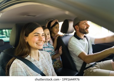 Excited To Get To The Beach! Beautiful Hispanic Family Feeling Happy While Driving To A Vacation Spot With Their Little Kids 