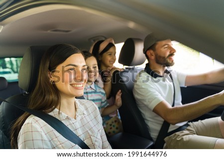 Excited to get to the beach! Beautiful hispanic family feeling happy while driving to a vacation spot with their little kids 