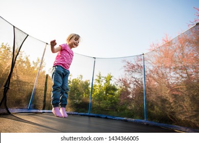 Excited Girl Enjoying The Bounce Off The Trampoline