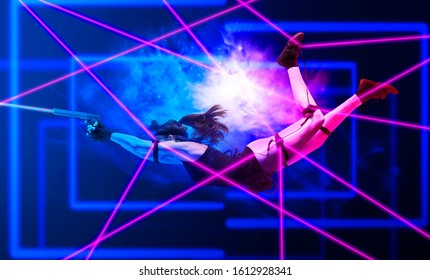 Excited Girl Holding Laser Pistol While Playing Lasertag Game. Mission: Impossible Concept