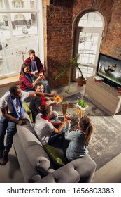 Excited Group Of People Watching American Football, Sport Match At Home. Multiethnic Group Of Emotional Friend, Fans Cheering For Favourite National Team, Drinking Beer. Concept Of Emotions, Support.