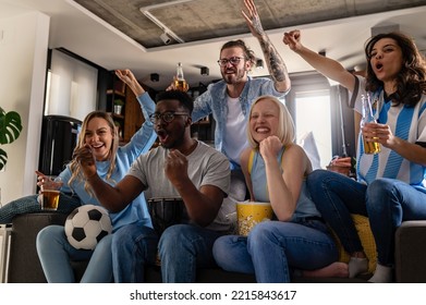 Excited group of people watching football soccer sports match at home. Multi-ethnic group of emotional friend fans cheering for their favorite national team, drinking beer.  - Powered by Shutterstock