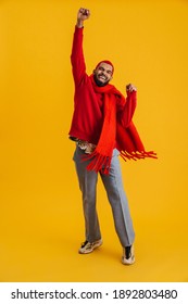 Excited Happy African Man Wearing Scarf Celebrating Isolated Over Yellow Background, Full Length