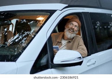 Excited happy older senior man driving rv camper van on vacation. Smiling mature active traveler sitting in campervan trailer looking outside enjoying view and camping tourism in nature travel park. - Powered by Shutterstock