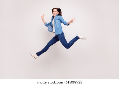 Excited Happy Pretty  Girl In Casual Jeans Clothes High Jump With Raised Hands And Legs, On White Background