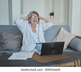 Excited Happy Senior Woman Is Actively Rejoicing Winning The Online Lottery, Mortgage Approval And Medical Tests. Big Earnings From Investing In Cryptocurrency And Bitcoins. Success Comes In Old Age.