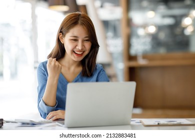 Excited Happy Woman Looking At The Laptop Computer Screen, Celebrating An Online Win, Overjoyed Young Asian Female Screaming With Joy, Isolated Over A White Blur Background