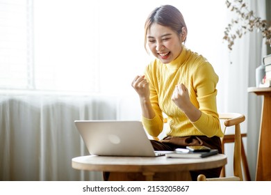 Excited happy woman looking at the laptop screen, celebrating an online win, overjoyed young Asian female screaming with joy, isolated over a white blur background - Shutterstock ID 2153205867